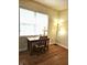 Well-lit office area with wooden desk and chair, large window, and laminate flooring at 6956 Park Square Dr # D, Avon, IN 46123