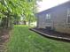 Green side yard with well-maintained lawn and landscaping along the side of the home at 6956 Park Square Dr # D, Avon, IN 46123
