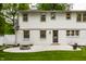 Backyard showcasing a patio with a fire pit and well-manicured lawn at 7105 Sylvan Ridge Rd, Indianapolis, IN 46240