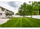 Expansive backyard featuring lush green lawn, basketball court, and white picket fence at 7105 Sylvan Ridge Rd, Indianapolis, IN 46240
