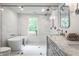 Bright, luxurious bathroom with double vanity, glass enclosed shower and freestanding soaking tub at 7105 Sylvan Ridge Rd, Indianapolis, IN 46240