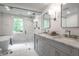 Bright, luxurious bathroom with double vanity, glass enclosed shower and freestanding soaking tub at 7105 Sylvan Ridge Rd, Indianapolis, IN 46240