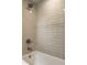 Bathroom shower featuring white tub and tile surround at 7105 Sylvan Ridge Rd, Indianapolis, IN 46240