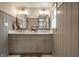 Bathroom featuring double vanity with gray cabinets and stylish lighting at 7105 Sylvan Ridge Rd, Indianapolis, IN 46240