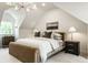 Bedroom showcasing an elegant bed, nightstand, and painting complemented by natural light from a window at 7105 Sylvan Ridge Rd, Indianapolis, IN 46240