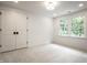 Bedroom featuring neutral carpet, double door closet and window overlooking greenery at 7105 Sylvan Ridge Rd, Indianapolis, IN 46240