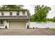 Charming two-story home featuring a gray painted garage and a white privacy fence with a gate at 7105 Sylvan Ridge Rd, Indianapolis, IN 46240