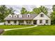 Charming home with white brick and siding, dormer windows, and a walkway leading to the front door at 7105 Sylvan Ridge Rd, Indianapolis, IN 46240