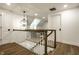 Bright hallway featuring hardwood floors, white trim, and a decorative wrought iron pendant light fixture at 7105 Sylvan Ridge Rd, Indianapolis, IN 46240
