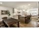 Spacious kitchen with a rustic dining table, central island with seating, and white cabinetry at 7105 Sylvan Ridge Rd, Indianapolis, IN 46240