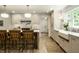 Bright kitchen with a farmhouse sink, wooden island, stainless steel appliances, and hardwood floors at 7105 Sylvan Ridge Rd, Indianapolis, IN 46240