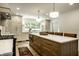 Modern kitchen featuring an island with seating, sleek appliances, and abundant cabinet space at 7105 Sylvan Ridge Rd, Indianapolis, IN 46240