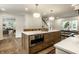 Kitchen island with seating, stainless steel microwave, and a view of the staircase at 7105 Sylvan Ridge Rd, Indianapolis, IN 46240