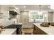 Open kitchen design features stainless steel appliances, marble countertops, and a bright window at 7105 Sylvan Ridge Rd, Indianapolis, IN 46240