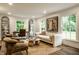 Bright living room with large windows, comfortable seating, and stylish décor; perfect for relaxation and entertaining guests at 7105 Sylvan Ridge Rd, Indianapolis, IN 46240