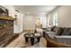 Open-concept living room with a fireplace, hardwood floors, and natural light at 7105 Sylvan Ridge Rd, Indianapolis, IN 46240