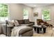 Relaxing living room with a comfortable couch, a fireplace, and natural light from multiple windows at 7105 Sylvan Ridge Rd, Indianapolis, IN 46240