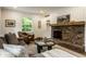 Cozy living room featuring a brick fireplace, and a comfortable couch at 7105 Sylvan Ridge Rd, Indianapolis, IN 46240
