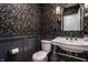 Chic powder room featuring botanical wallpaper, a vintage-style sink, and elegant lighting for a stylish space at 7105 Sylvan Ridge Rd, Indianapolis, IN 46240