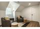 Cozy sitting area with wood floors, two armchairs and side tables illuminated by natural light at 7105 Sylvan Ridge Rd, Indianapolis, IN 46240