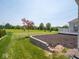 Spacious backyard with lush green grass and mature trees at 7329 Birch Leaf Dr, Indianapolis, IN 46259