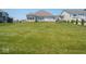 Large grassy backyard with mature landscaping at 7329 Birch Leaf Dr, Indianapolis, IN 46259
