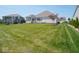 Well-manicured backyard with green lawn and beautiful landscaping at 7329 Birch Leaf Dr, Indianapolis, IN 46259