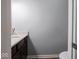 Half bath featuring sleek vanity with gray countertop and wood-look floors at 7329 Birch Leaf Dr, Indianapolis, IN 46259