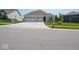 A charming single-story home features a brick facade, a well-manicured lawn, and an attached two-car garage at 7329 Birch Leaf Dr, Indianapolis, IN 46259