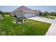 Single-story brick home with attached garage, beautifully landscaped yard and concrete driveway at 7329 Birch Leaf Dr, Indianapolis, IN 46259