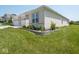Beautifully landscaped front yard with lush green lawn, and a brick single-story home with attached garage at 7329 Birch Leaf Dr, Indianapolis, IN 46259