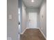 Hallway with hard surface floors, neutral paint and a white front door at 7329 Birch Leaf Dr, Indianapolis, IN 46259