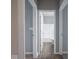 Hallway leading to a bathroom with wood floors at 7329 Birch Leaf Dr, Indianapolis, IN 46259