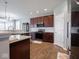 The kitchen features stainless steel appliances, wood cabinets, quartz countertops, and recessed lighting at 7329 Birch Leaf Dr, Indianapolis, IN 46259