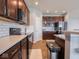 This kitchen features dark wood cabinets, stainless steel appliances, and quartz countertops at 7329 Birch Leaf Dr, Indianapolis, IN 46259