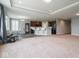 Open floorplan living room into a modern kitchen with a central island and barstool seating at 7329 Birch Leaf Dr, Indianapolis, IN 46259