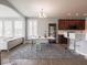 Living room adjacent to kitchen and dining area featuring a decorative rug and hardwood flooring at 7329 Birch Leaf Dr, Indianapolis, IN 46259