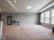 Bright living room with large windows and neutral carpet and paint at 7329 Birch Leaf Dr, Indianapolis, IN 46259