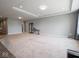 Open floorplan living room featuring modern recessed lighting and neutral carpeting at 7329 Birch Leaf Dr, Indianapolis, IN 46259