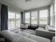 Bright sunroom with three large windows and a glass slider to the rear patio at 7329 Birch Leaf Dr, Indianapolis, IN 46259