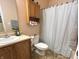 Bathroom showcasing a vanity sink, toilet, and shower with a white curtain at 7611 Cloudy Ct, Camby, IN 46113