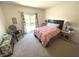 Bright bedroom featuring a cozy bed, a sliding glass door, and neutral carpeting at 7611 Cloudy Ct, Camby, IN 46113