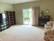Spacious living room showcasing carpet floors, sliding glass doors, and neutral color palette at 7611 Cloudy Ct, Camby, IN 46113