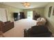 Large living area featuring plush seating, sleek TV setup, and a patio door to the backyard at 7611 Cloudy Ct, Camby, IN 46113