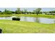 Picturesque pond surrounded by well-maintained green space, offering a tranquil view at 7611 Cloudy Ct, Camby, IN 46113
