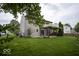 Spacious backyard featuring a well-maintained lawn, charming pergola, and sliding glass doors to the home's interior at 7657 Wheatgrass Ln, Noblesville, IN 46062