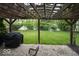 The outdoor patio features a gravel base, wooden pergola, outdoor grill, and manicured backyard lawn at 7657 Wheatgrass Ln, Noblesville, IN 46062