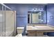 Well-lit bathroom featuring a shower with glass doors, and modern vanity at 7657 Wheatgrass Ln, Noblesville, IN 46062