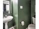 Small bathroom featuring a pedestal sink and dark green walls at 7657 Wheatgrass Ln, Noblesville, IN 46062