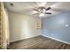 A spacious bedroom featuring neutral wallpaper, blue accent wall, a built-in shelf, and hard surface flooring at 7657 Wheatgrass Ln, Noblesville, IN 46062